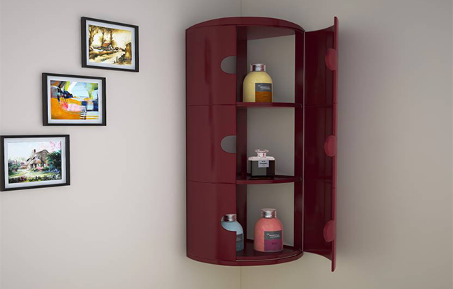 A red corner cabinet with door ABS, featuring shelves with bathroom products, positioned in a room with wall-mounted frames.