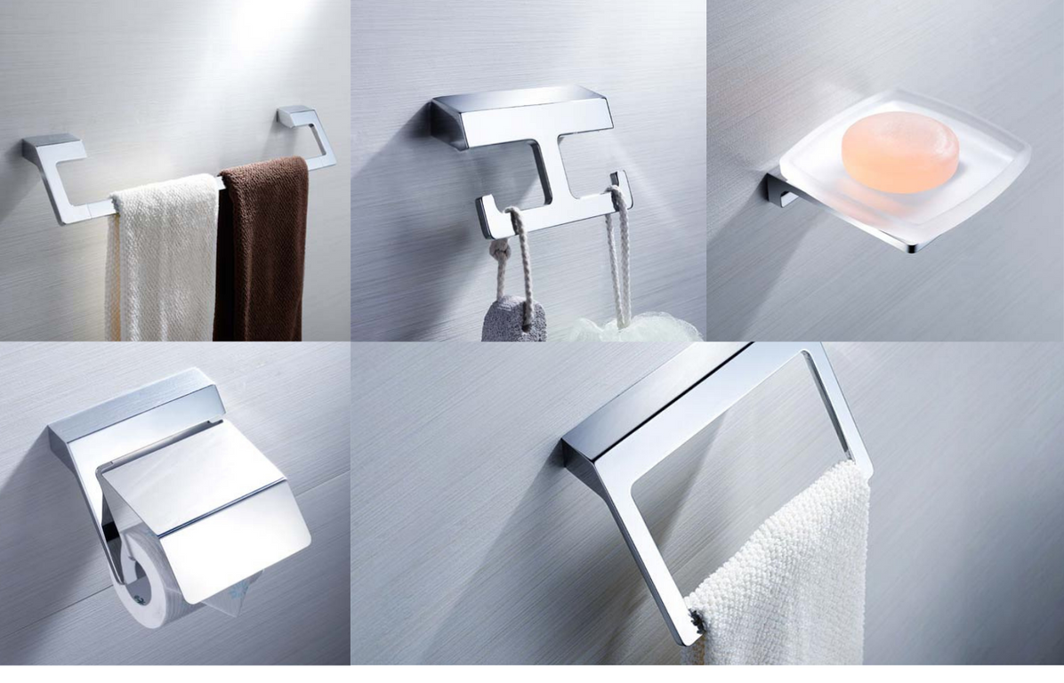 A set of chrome bathroom accessories including a toilet paper holder, towel hooks, and a robe hook, all mounted on a wall.