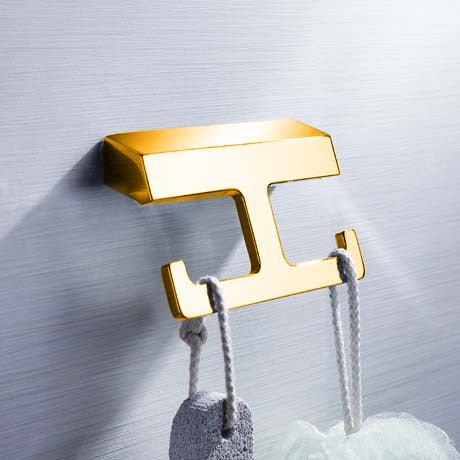A gold-colored bathroom accessory dress hook.