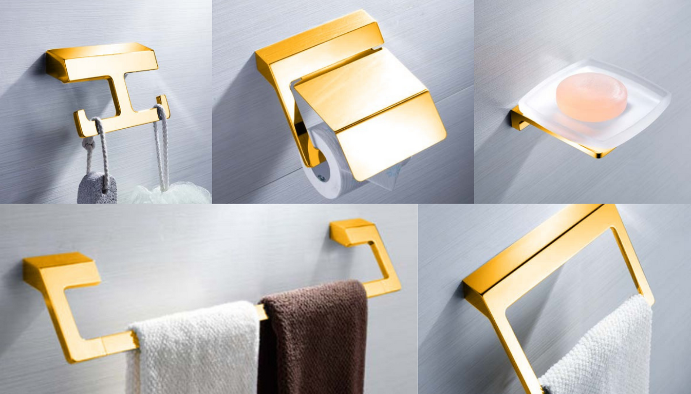 A set of gold-colored bathroom accessories including a toilet paper holder, a towel rack, and other items.