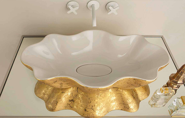 A luxurious gold and white bathroom vanity with a unique design, featuring a basin and fittings.