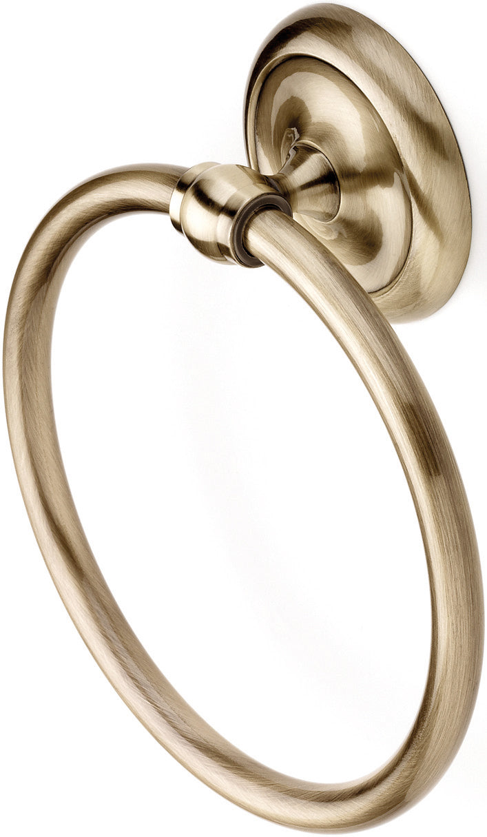 A gold-colored metal towel ring with a wall-mounted circular holder.