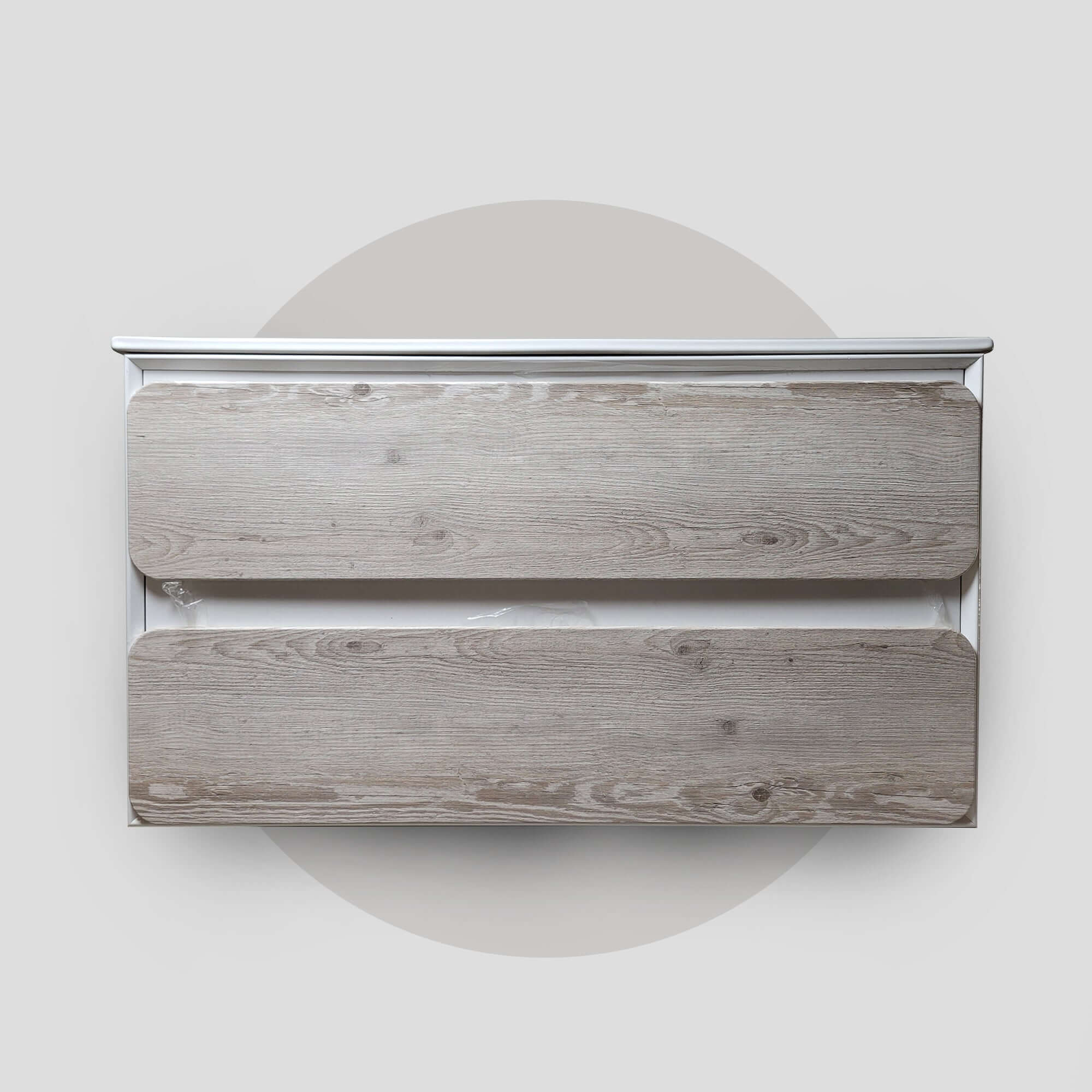 A bathroom vanity unit with a wood finish, featuring a top surface without handles and two drawers below, set against a plain background.