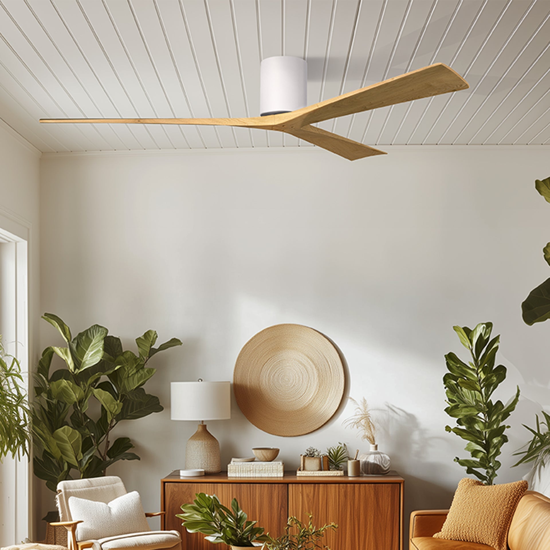 Modern ceiling fan with wooden blades in a stylish living room setting with plants and decorative elements.