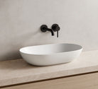 modern wash basin oval white installed on bathroom vanity