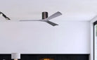 Ceiling fan mounted on a white ceiling with a fireplace and mirror in the background.