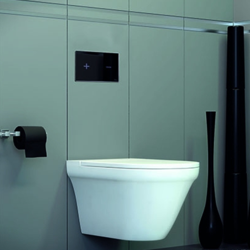 OLI Glassy glass flush plate installed on concealed toilet wall Pakistan — OLI exclusive Sardar & Co