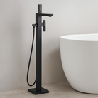 OMSA YD8812 Matte Black square floor mount faucet installed beside freestanding bathtub — article YD8812, luxury bathroom Pakistan, Sardar & Co Rawalpindi